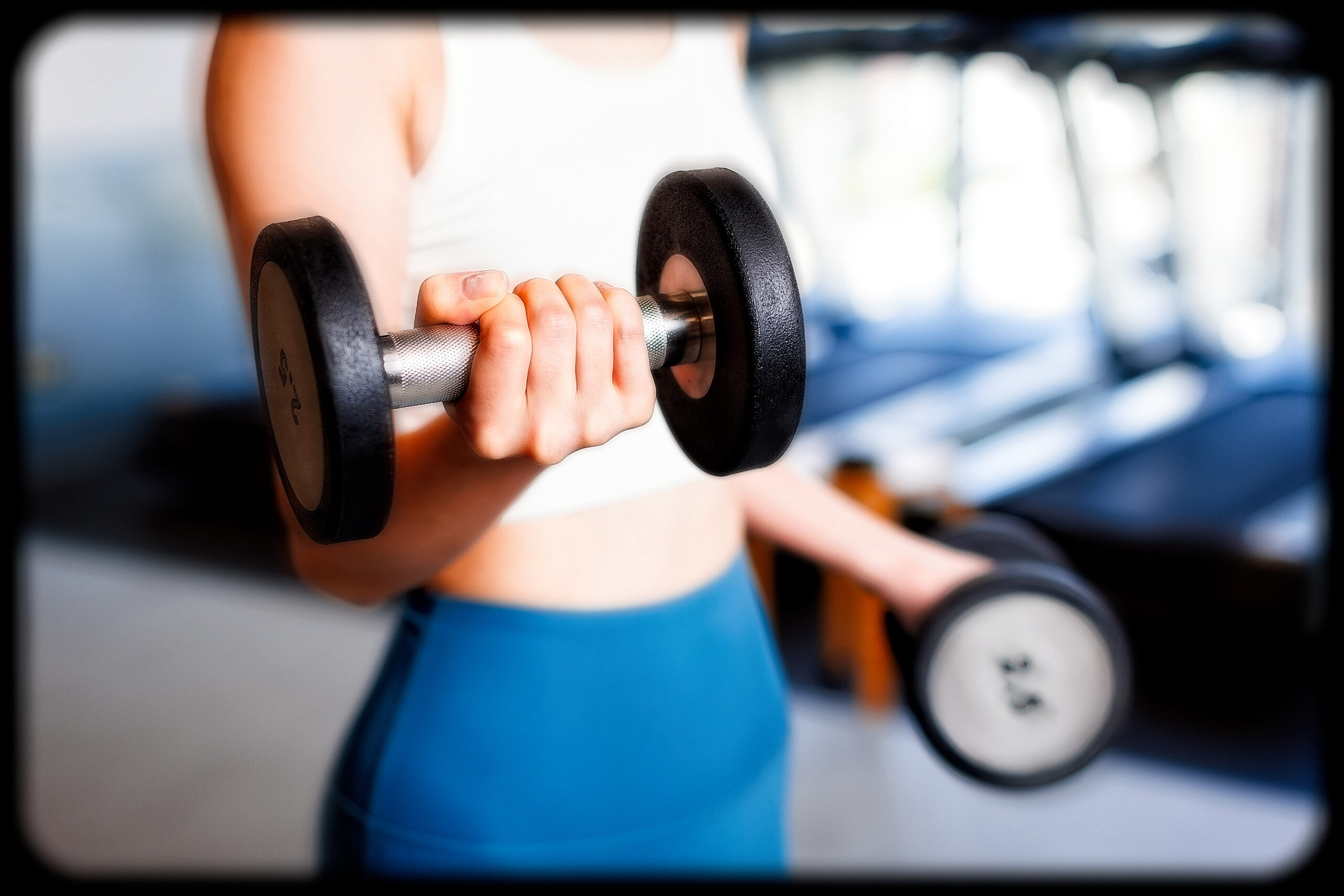 Woman performing a strength-training exercise at a fitness studio